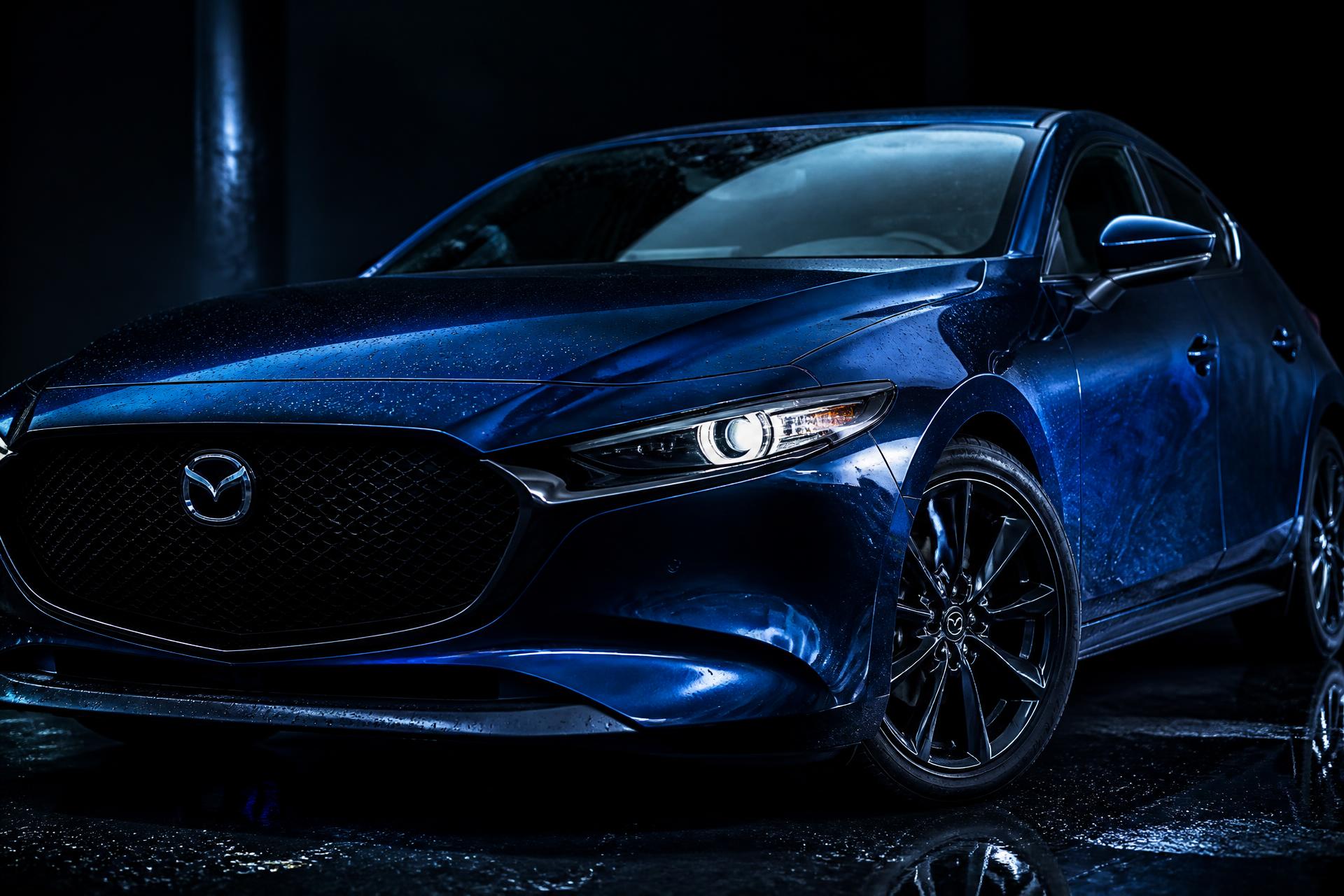 Glossy black luxury vehicle with blue lighting reflections